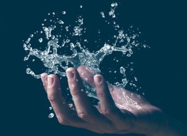 A human hand holding a graphic splash of water MAIN