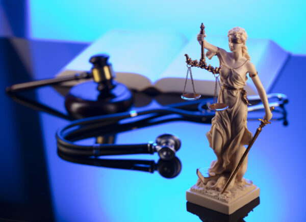 Gavel Themis legal code and stethoscope on the glass table
