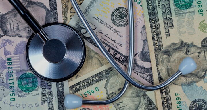 Stethoscope lying on top of paper money